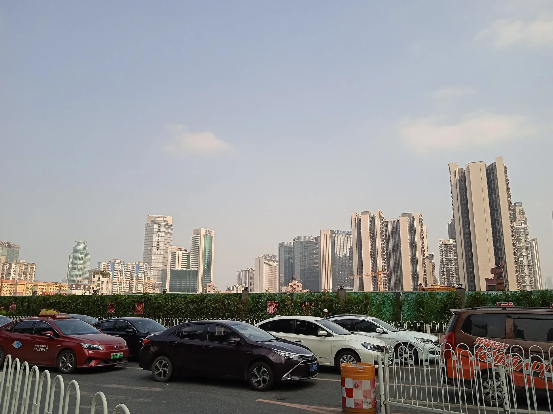 Zhujiang New Town's contemporary towers seen from a broad Guangzhou street.