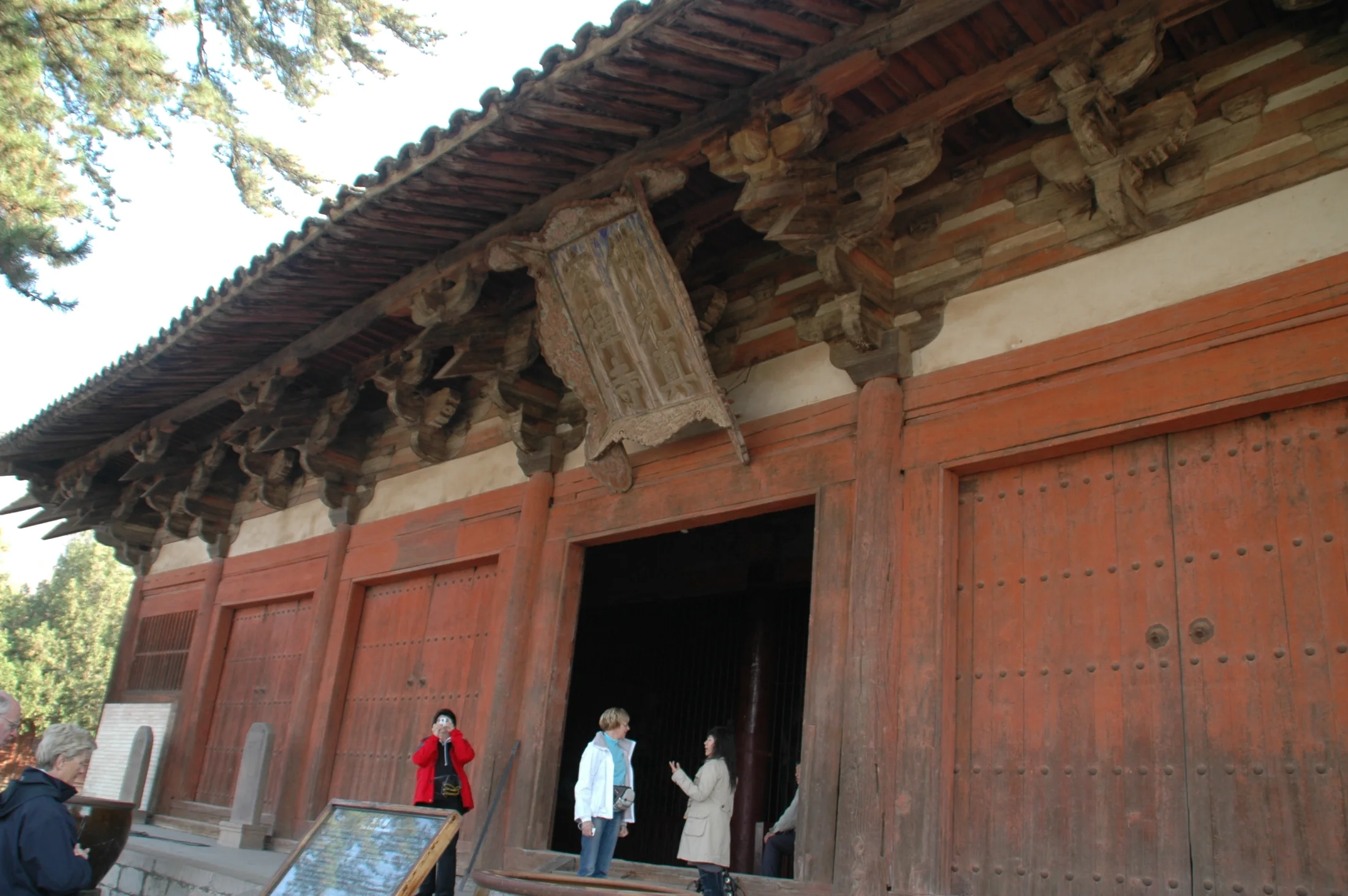 The timber facade and deep bracket sets of Foguang Temple's East Hall rise above visitors at Mount Wutai in Shanxi.