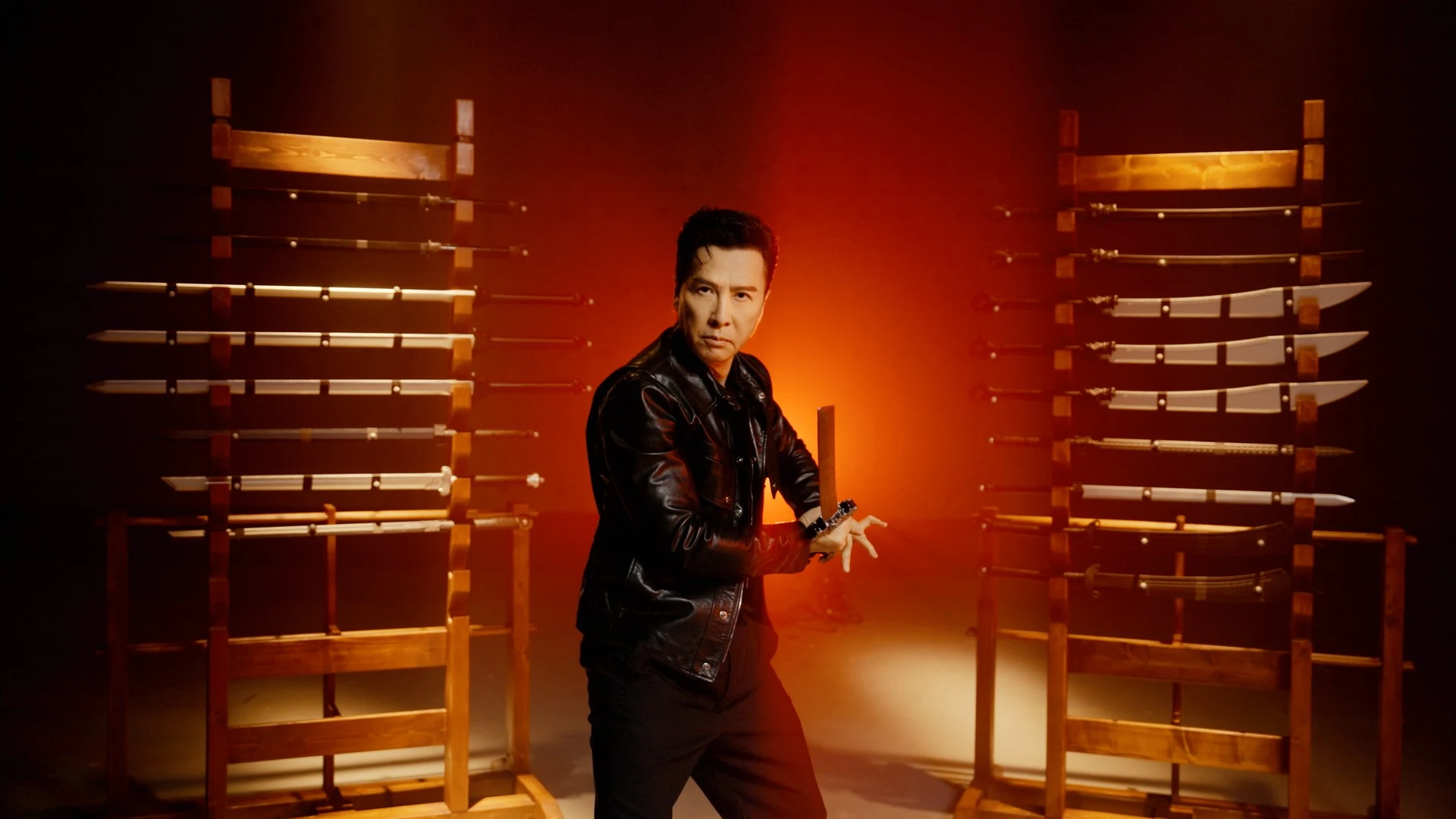 Donnie Yen stands in front of weapon racks during Phantom Blade Zero production footage.