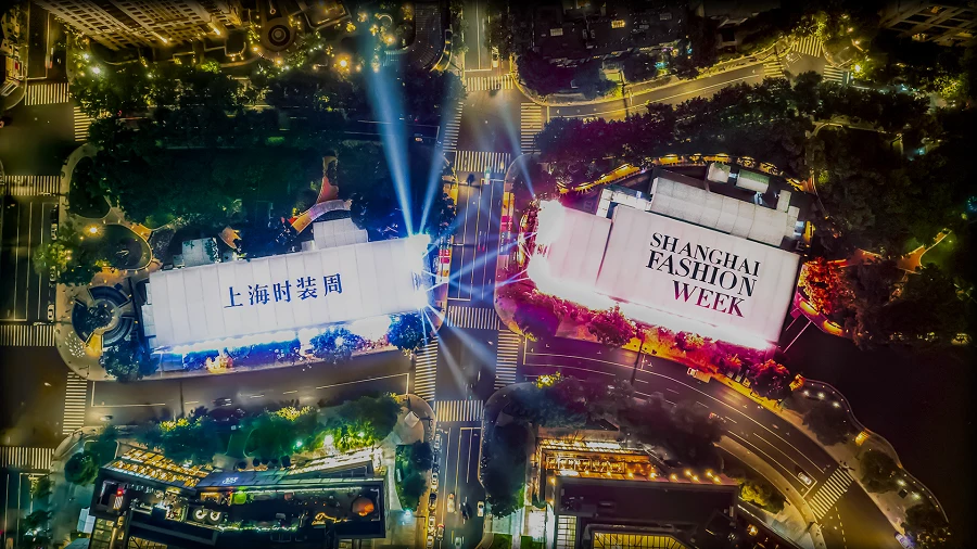 A Shanghai Fashion Week venue places a runway presentation inside a contemporary city setting.