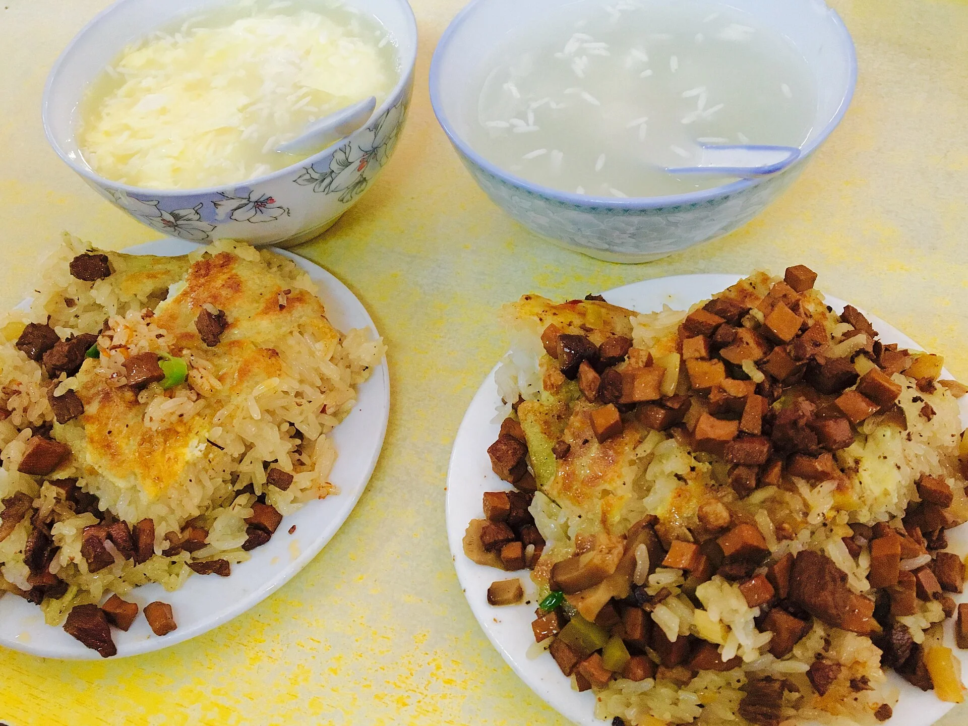 Cut pieces of Wuhan doupi reveal glutinous rice and savory filling beneath a golden outer layer.
