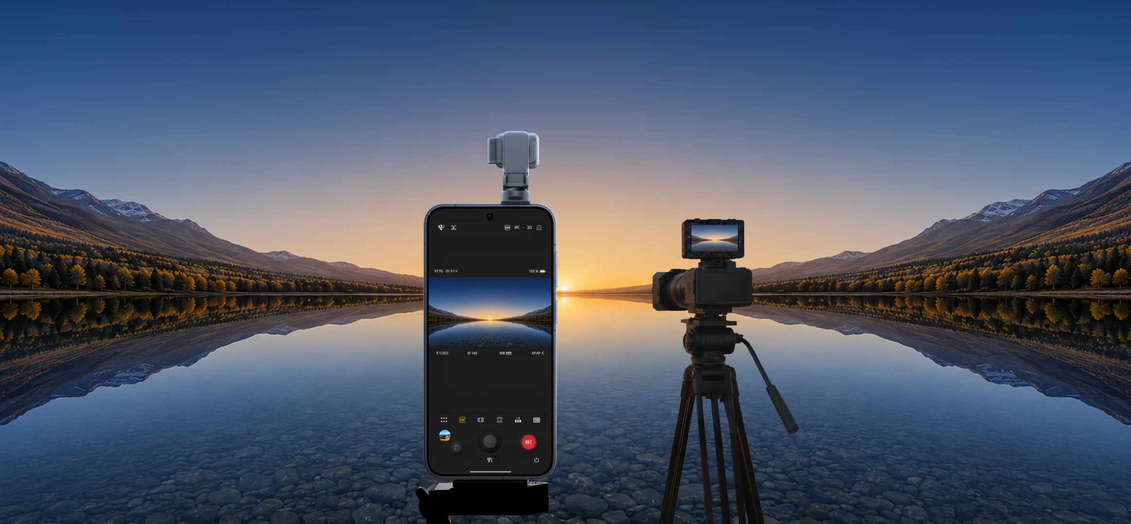 The silver HONOR Robot Phone stands beside a cinema camera at a mountain lake, with its motorized gimbal camera raised above the phone.