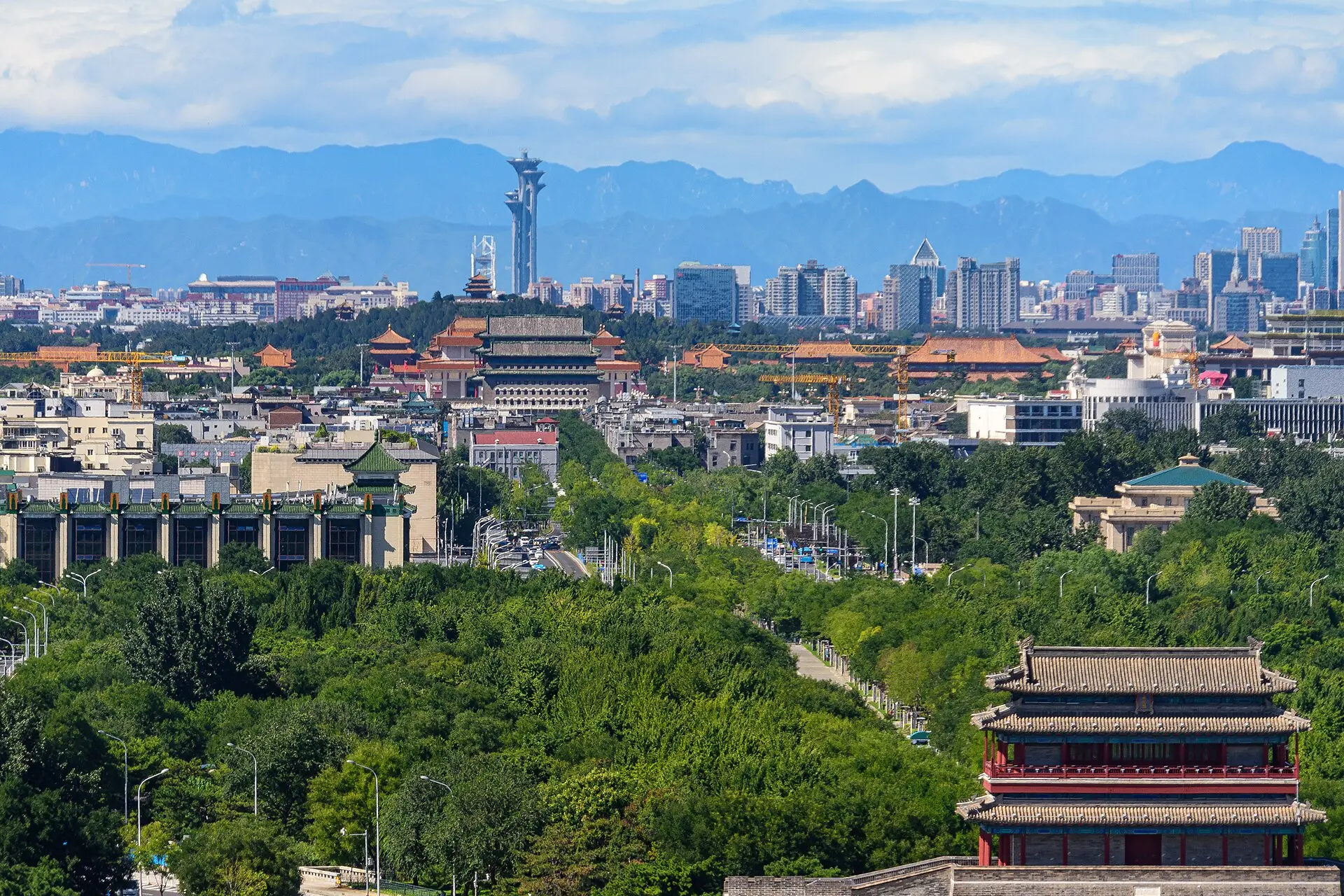 Beijing's central north-south line seen from Yongdingmen, with historic gates, Tiananmen and the Olympic Tower aligned toward the mountains.